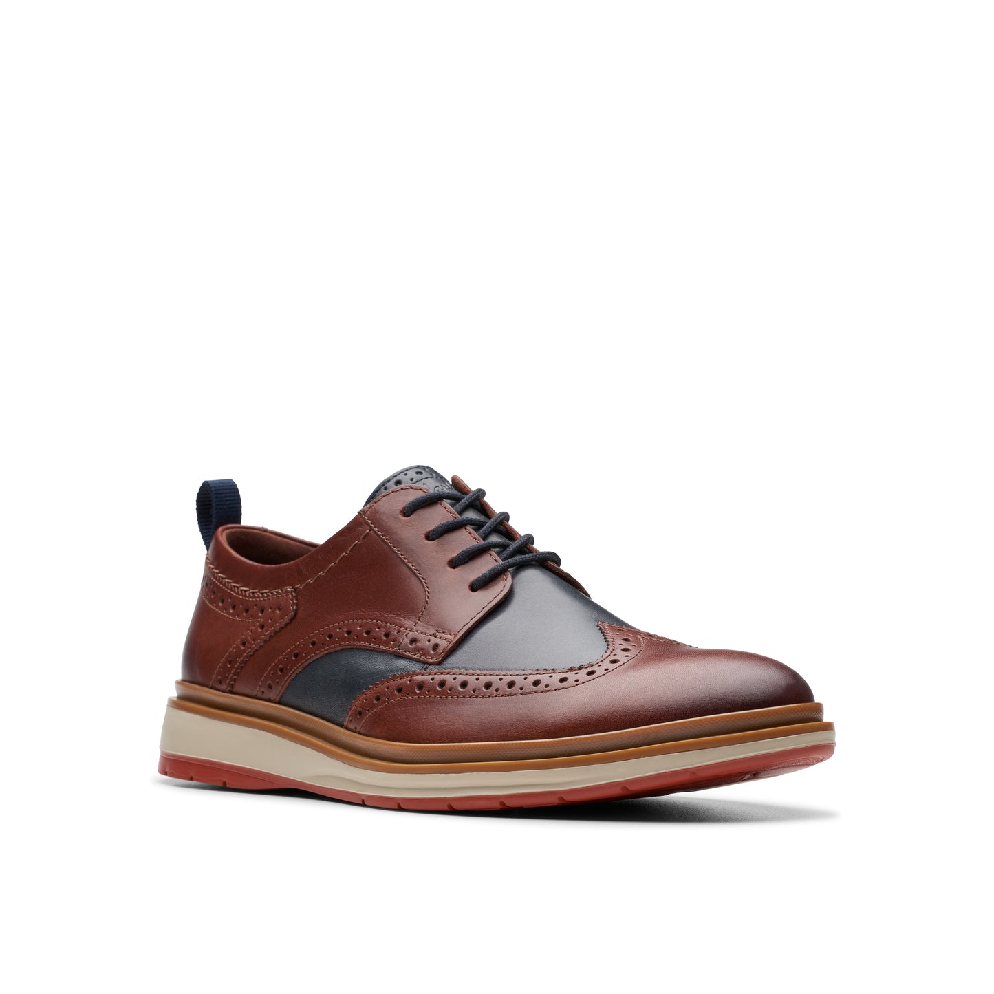 A brown, leather wingtip dress shoe with a thick sole, black laces, and navy accents.