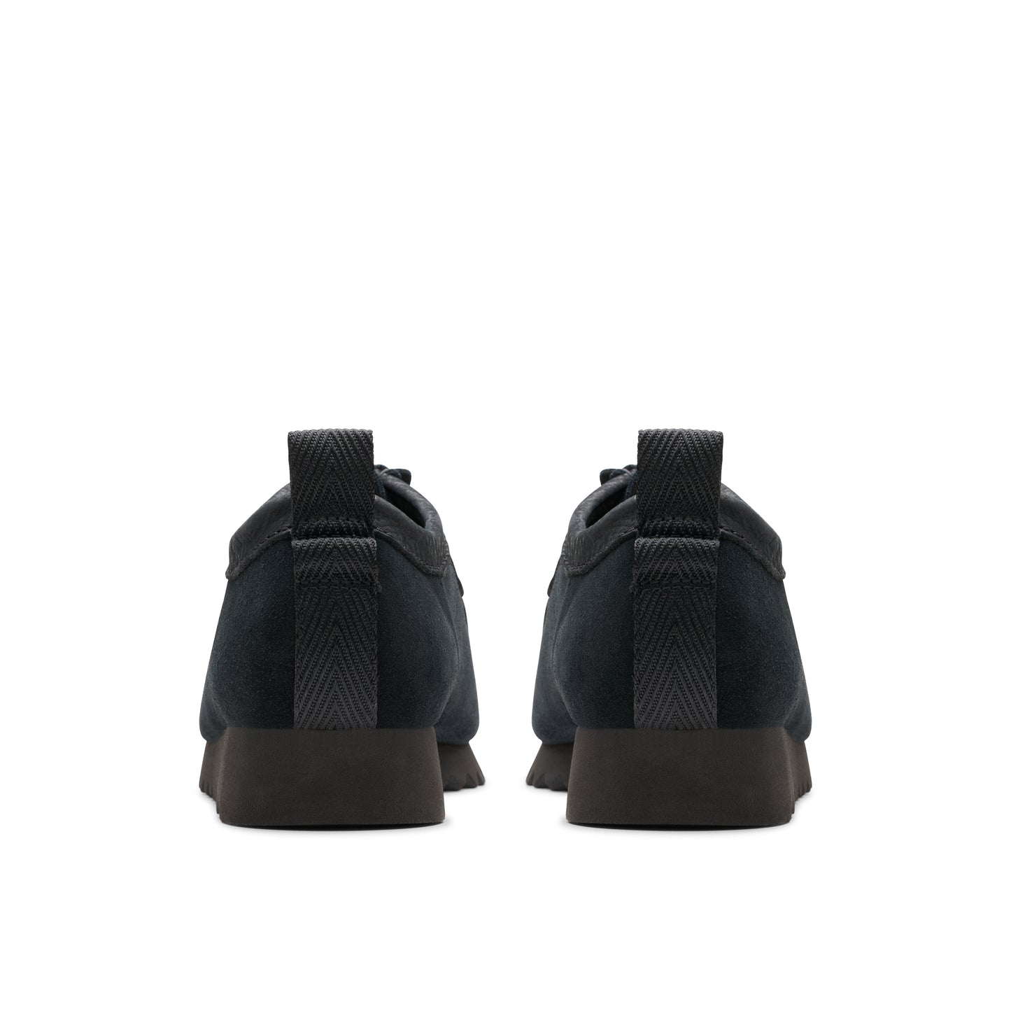 Rear view of two black suede shoes with matching heel, lace-up.