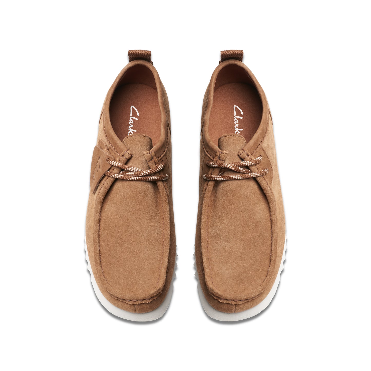 Pair of brown moccasin-style shoes with white soles and white laces.