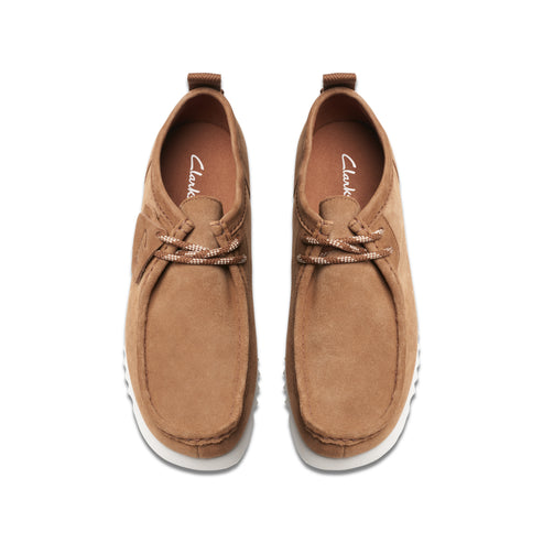 Pair of brown moccasin-style shoes with white soles and white laces.