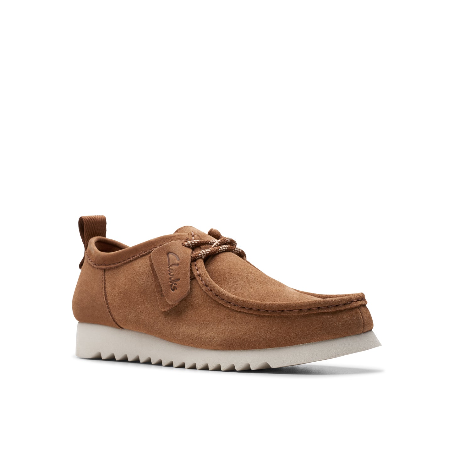 Brown suede casual shoe with a white sole and tongue tag.