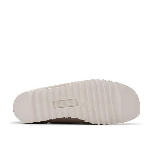 Beige slipper sole with horizontal ridges and a recessed logo in the center.
