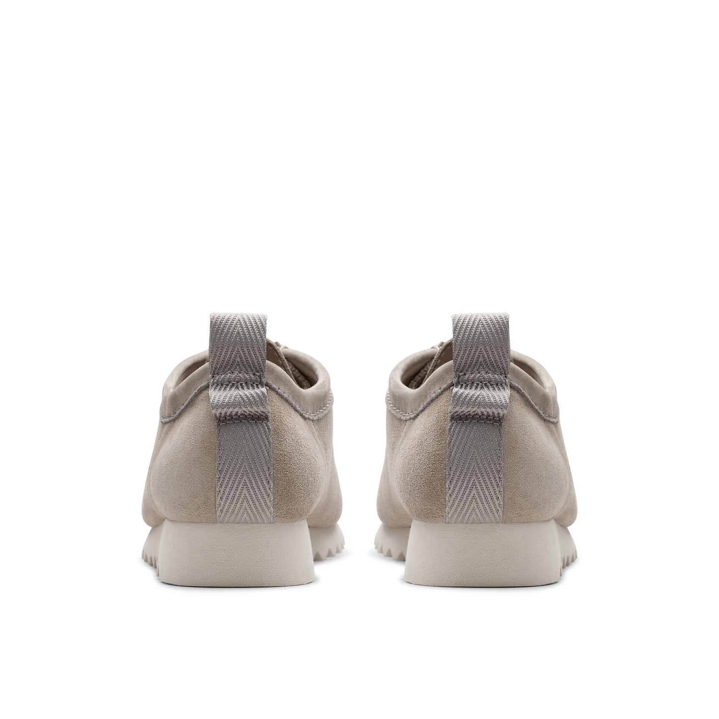 Back view of two tan nubuck shoes with grey fabric heel-pulls.