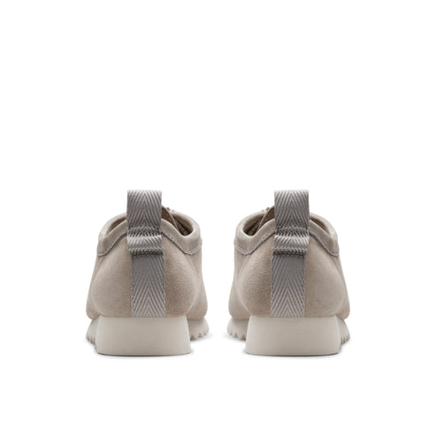 Back view of two tan nubuck shoes with grey fabric heel-pulls.