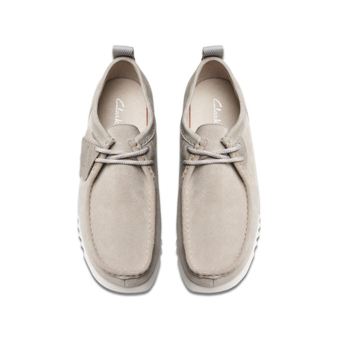 Overhead view of two gray nubuck leather lace-up shoes with a white sole.