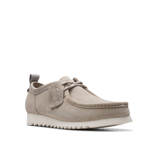 Beige suede moccasin-style shoe with off-white textured sole.