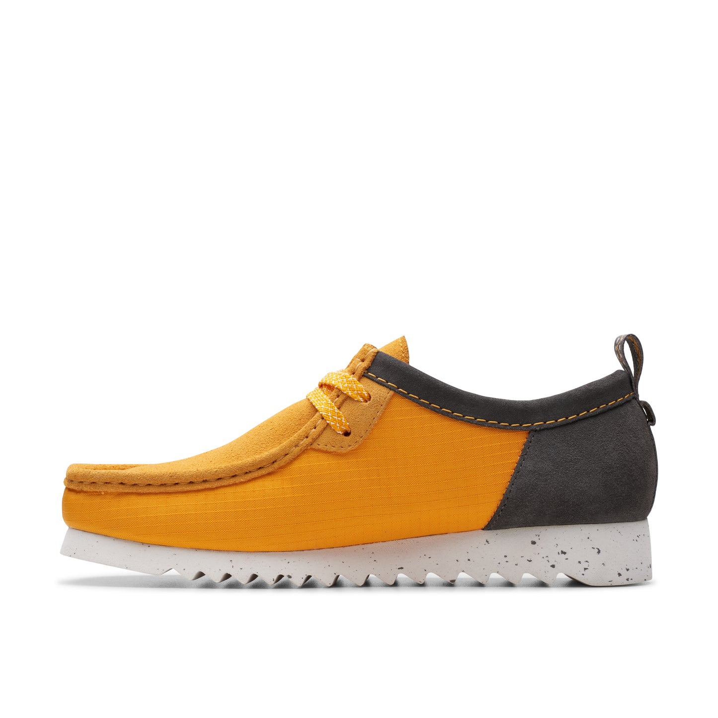 A yellow suede shoe with gray trim and white sole.