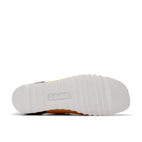 Bottom view of a shoe with a white sole with a grid pattern.