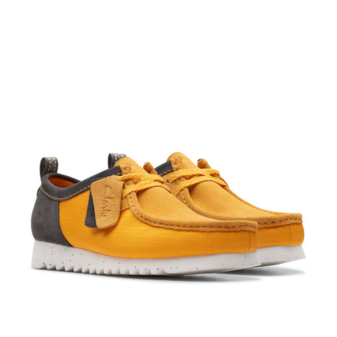 Low-cut yellow shoes with white speckled soles, grey accents, and yellow laces.