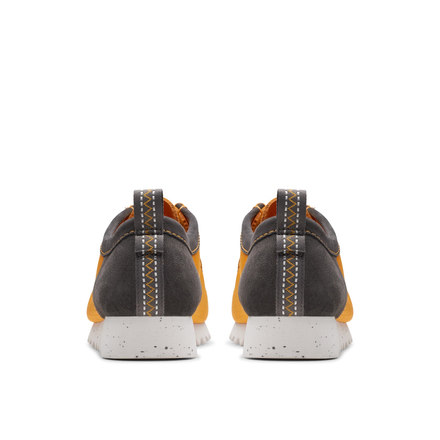 Back view of two orange and gray athletic shoes with white speckled soles.