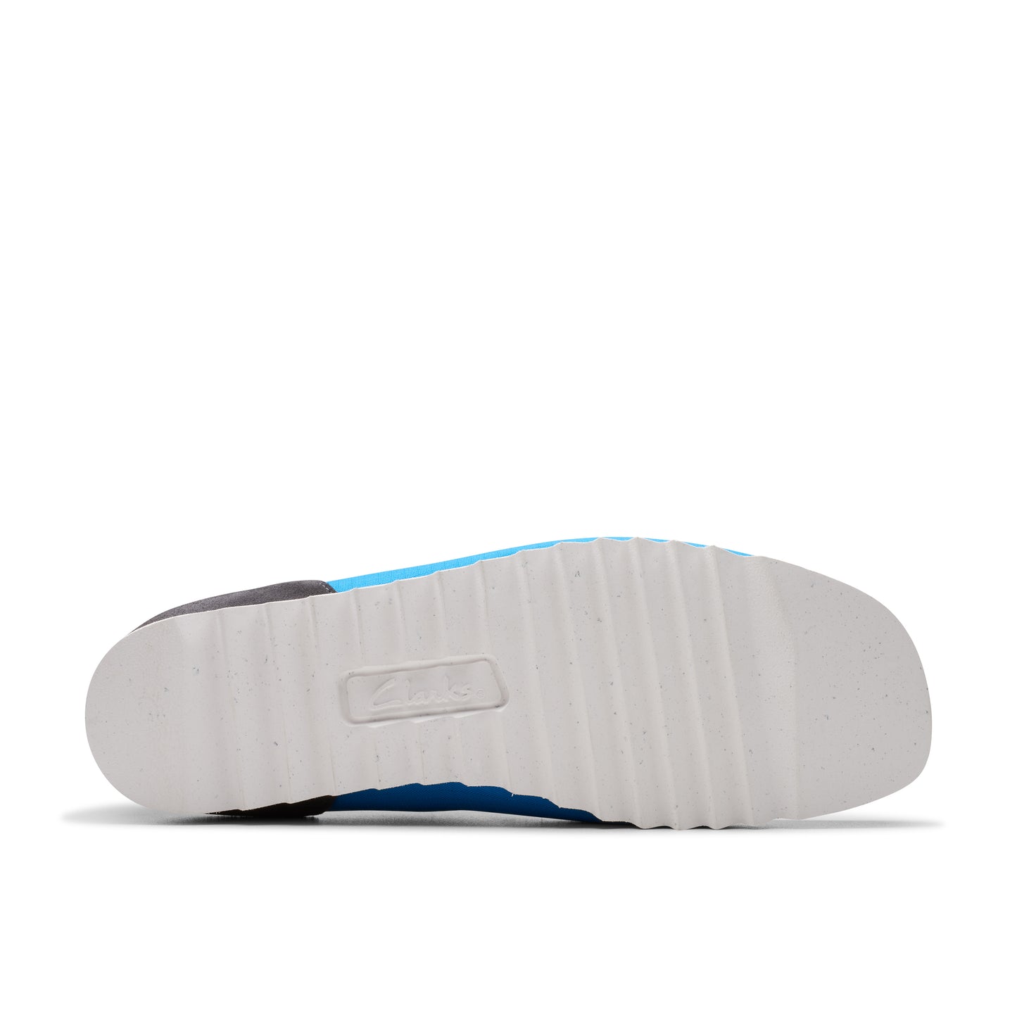 A bottom view of a shoe with a thick, white sole that has a textured pattern.