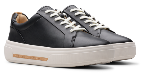 Black leather sneaker with white laces and platform sole.