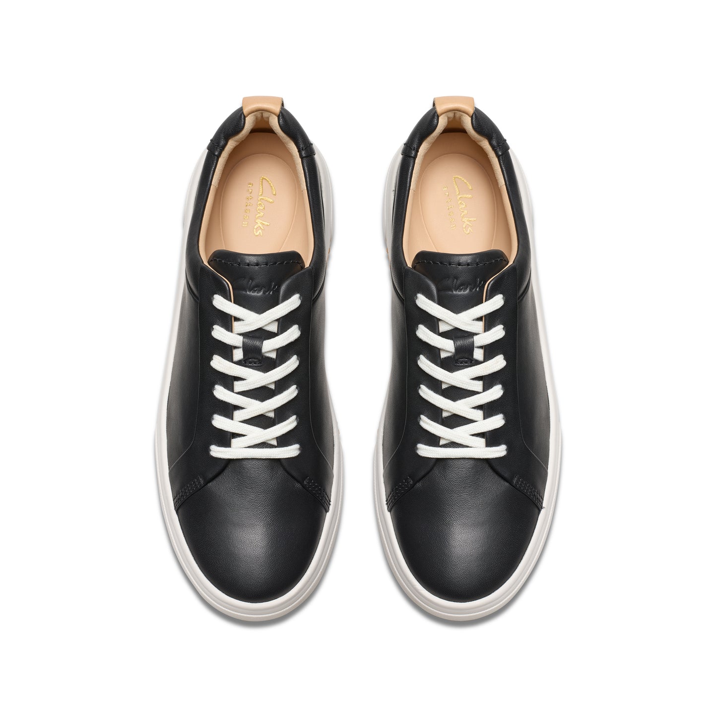 Overhead shot of black leather sneakers with white laces and white soles.