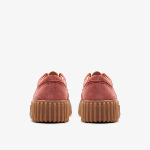 View of the rear of two red suede flat shoes with brown ridged soles.