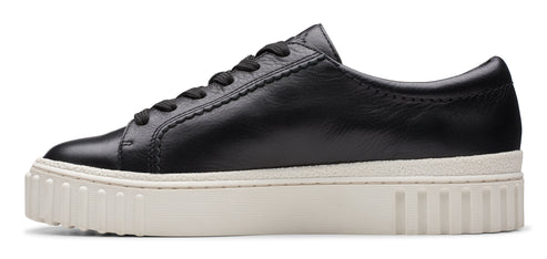 Black leather sneaker with a thick white sole.