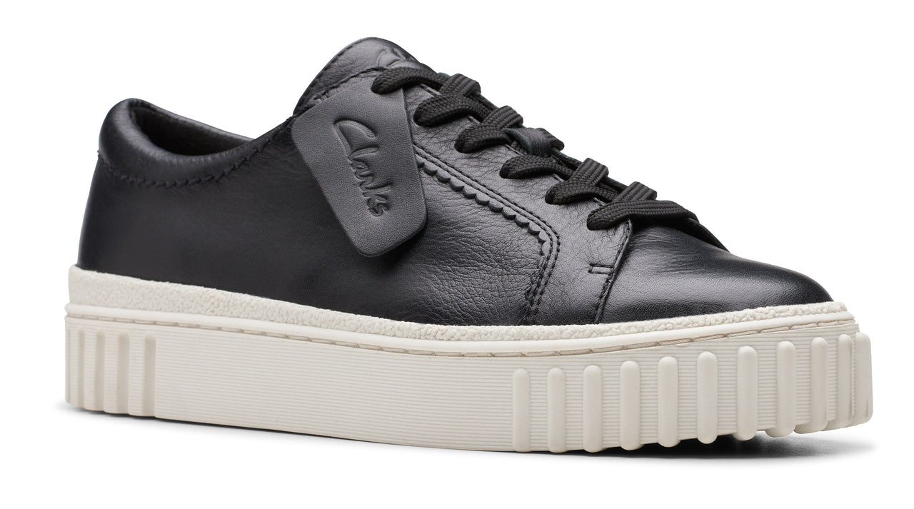 Black leather sneaker with thick white platform sole.