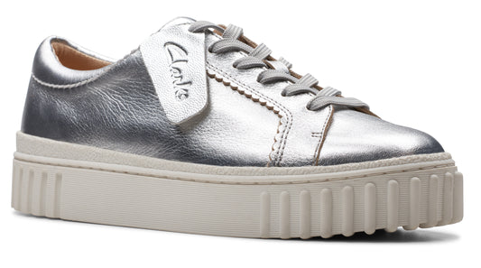 Silver leather sneaker with off-white sole and tag that says "Clarks".