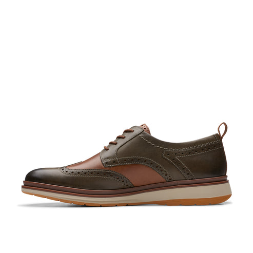 Olive and tan leather wingtip shoe with laces and a light sole.