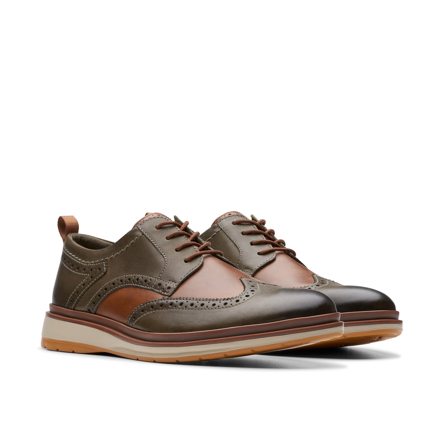 A pair of olive green and brown lace-up wingtip shoes with a beige sole.