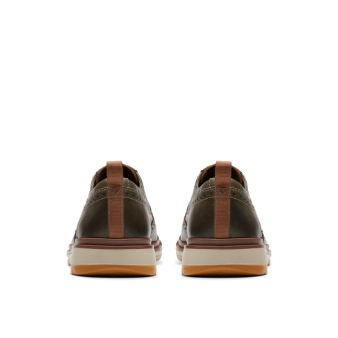 Pair of laced olive-green dress shoes showing tan heel tabs and soles from the rear.