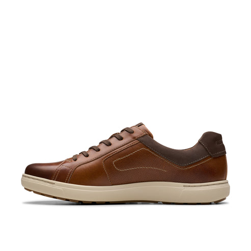 Side view of a brown leather tennis shoe with light-colored sole and dark brown laces.