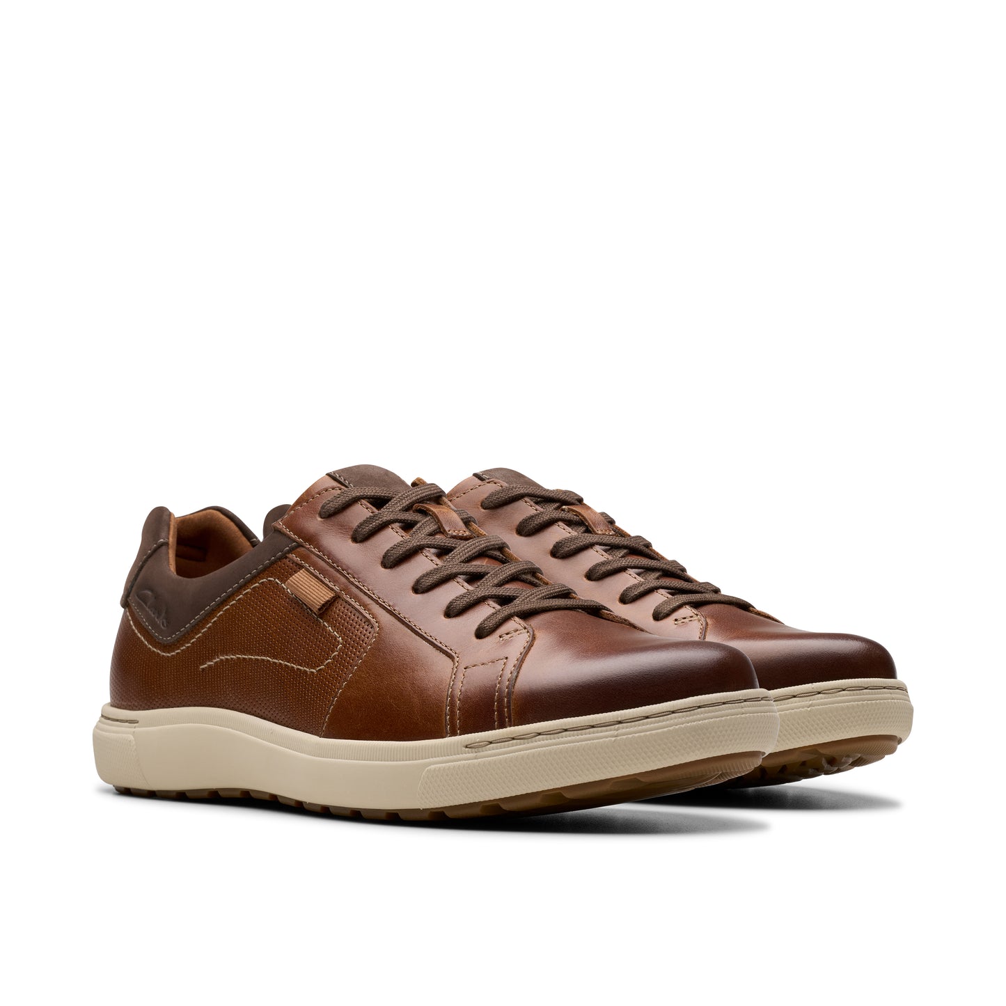 Pair of brown leather casual shoes with light beige soles and lace up closure.