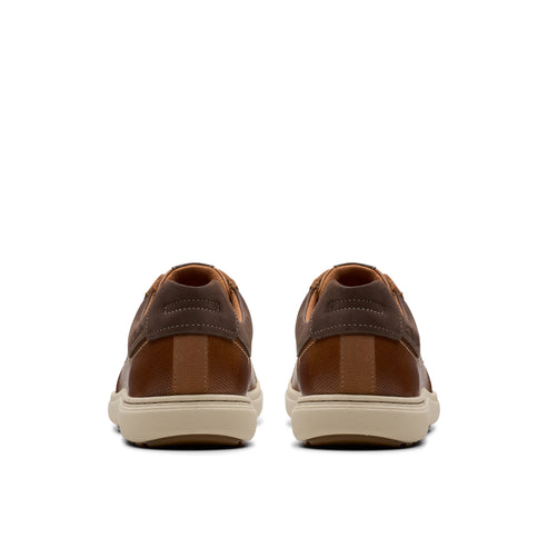 Pair of brown leather sneakers seen from behind.