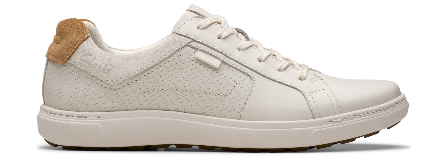 A white leather sneaker with a tan heel.