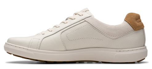 A white leather sneaker with a tan heel.