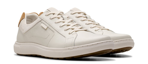 Pair of white leather sneakers with tan accents.