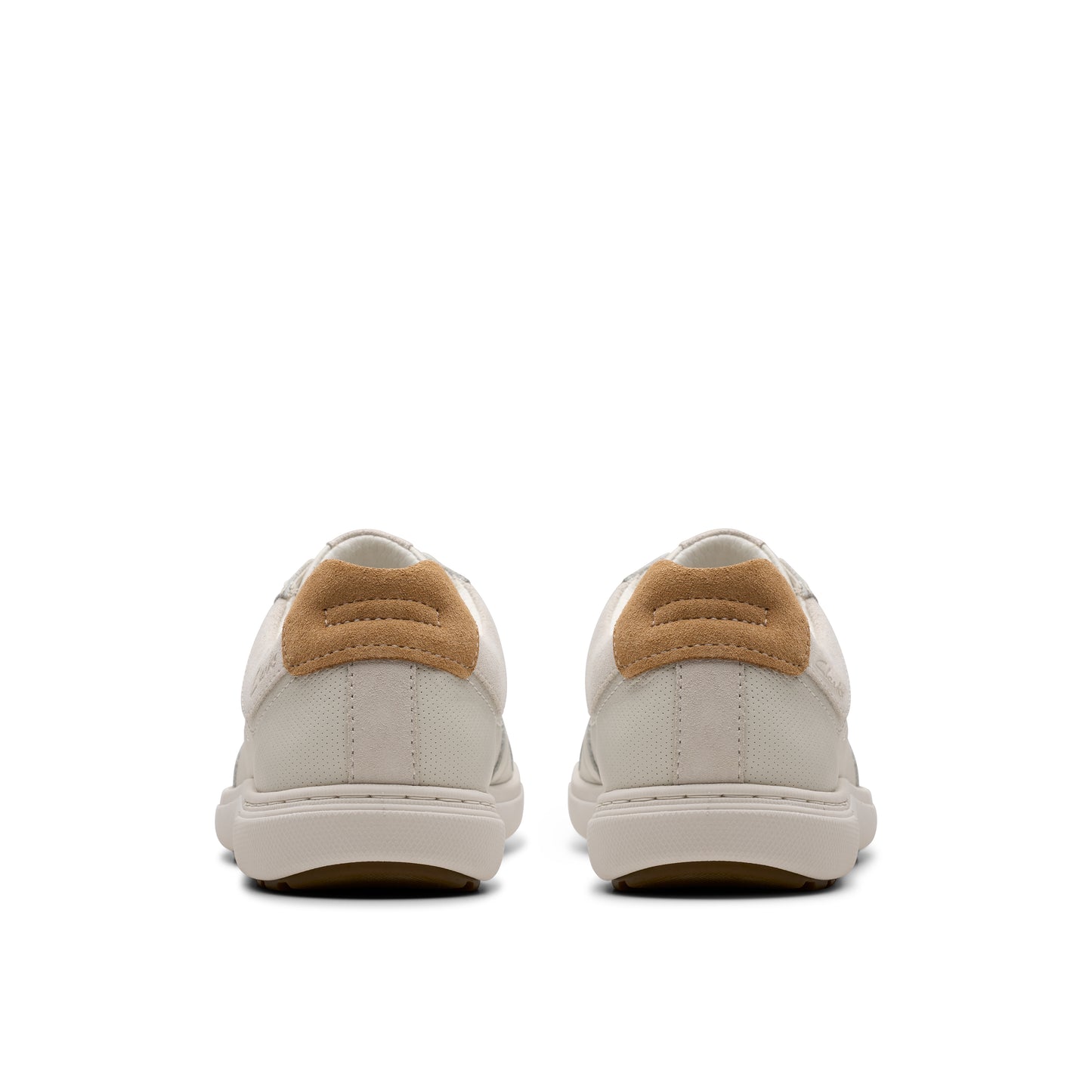 Rear view of matching white sneakers with tan suede heel tab.
