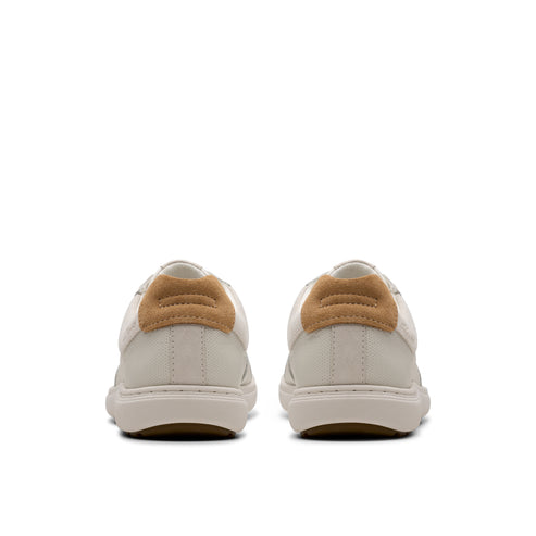 Rear view of matching white sneakers with tan suede heel tab.