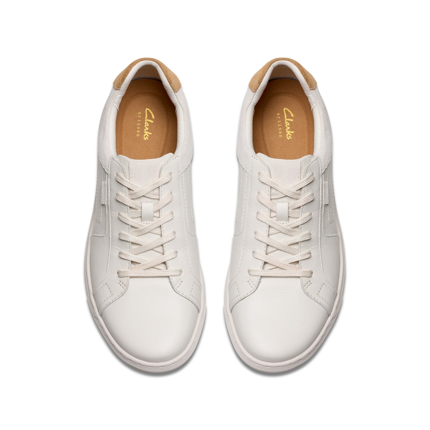 Top-down view of two white leather sneakers with beige lining.