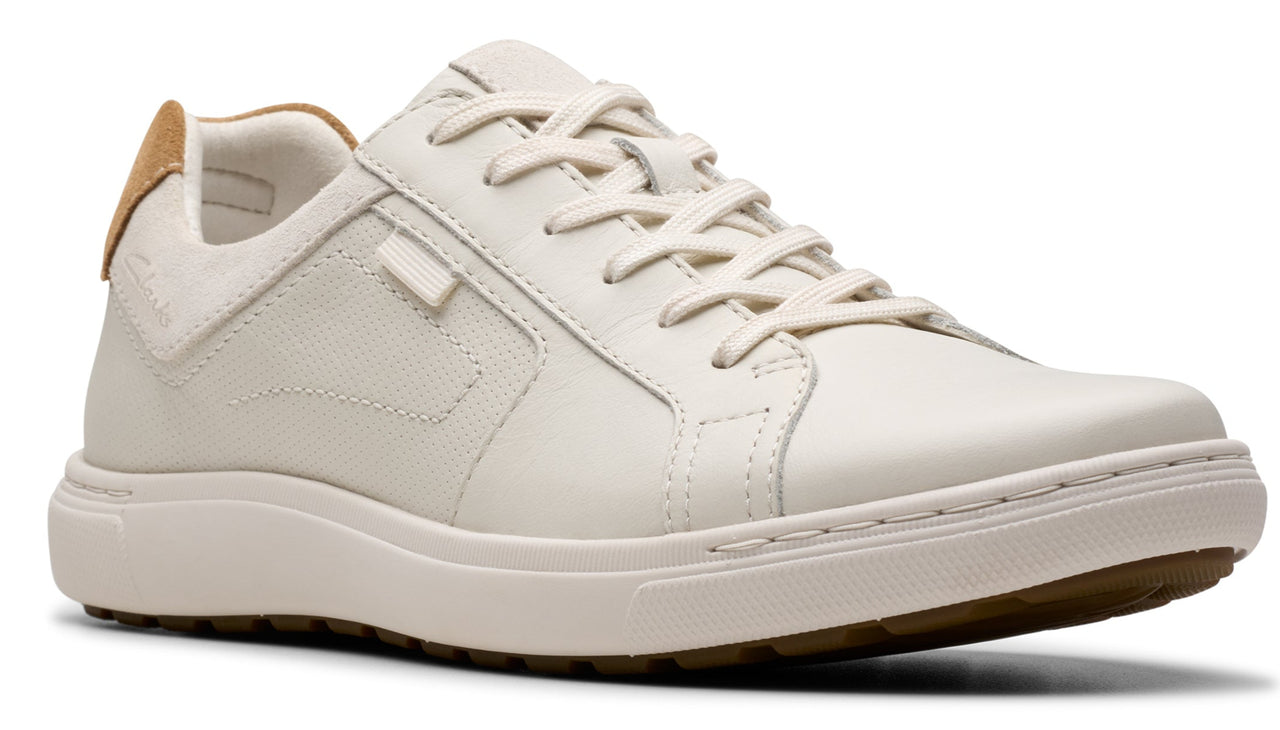 Off-white leather sneaker with laces and tan heel.
