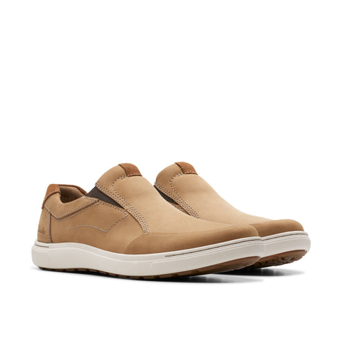 A pair of light brown slip-on shoes with white soles.