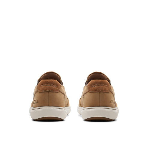 Pair of casual tan slip-on shoes with white soles, rear view.