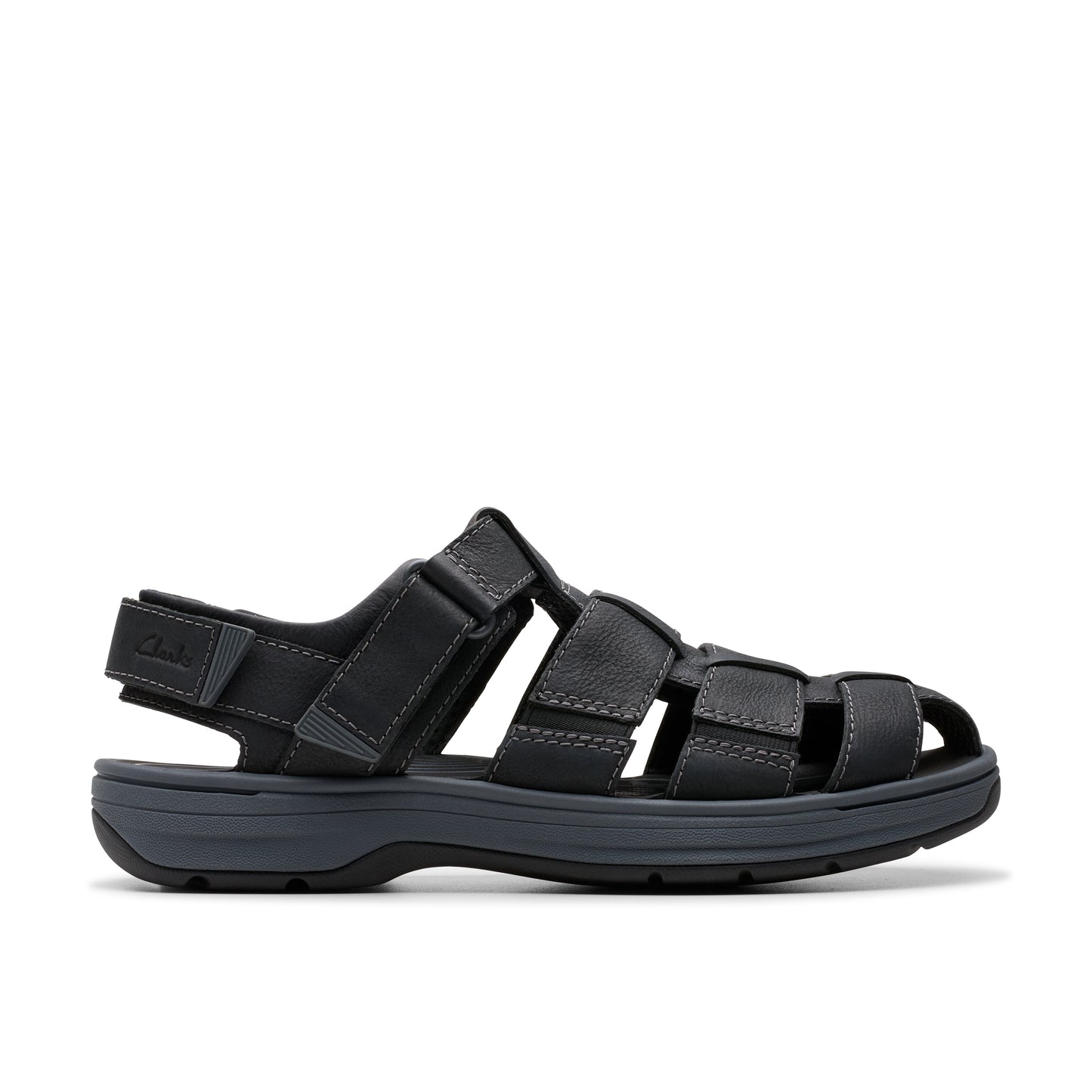 A low profile dark gray sandal with a flat heel, featuring woven straps and an adjustable heel strap.