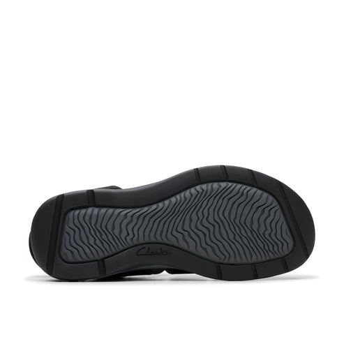 Sole of a black shoe with a wavy pattern.