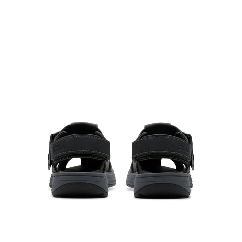 Rear view of two dark colored sandals with open top and velcro straps.