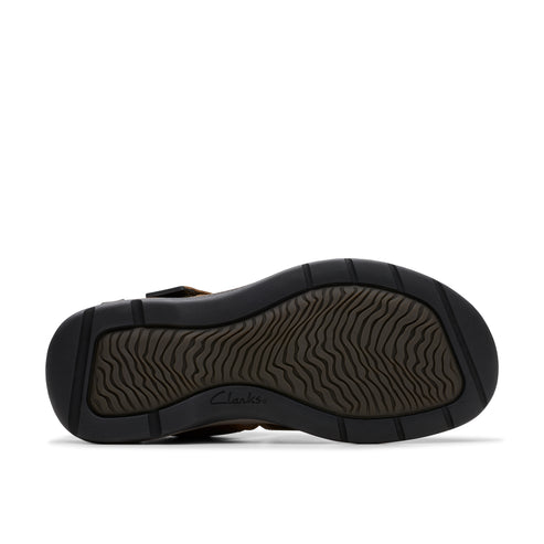 Bottom view of a sandal featuring a dark brown textured sole.