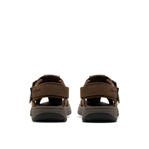 Pair of brown sandals viewed from the rear, showing straps and soles.