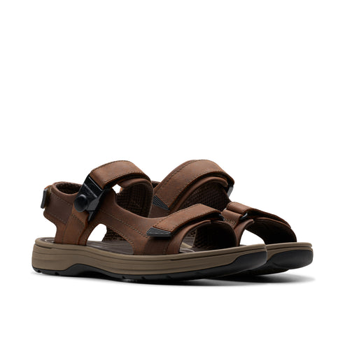 Pair of brown leather sandals with velcro straps and black buckle