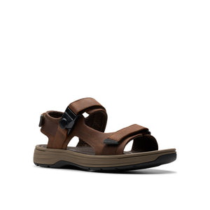 Brown sandal with adjustable straps and buckle.