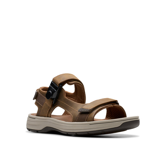 Brown sandal with velcro straps and a black buckle.