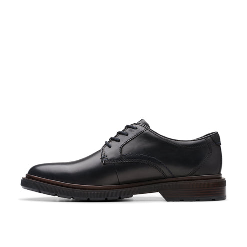 Black leather dress shoe with a rounded toe and a lace-up closure.