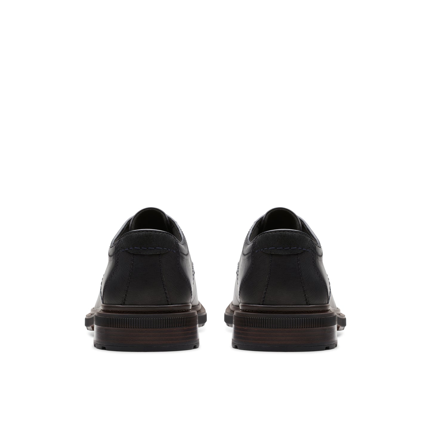 Pair of black leather dress shoes, rear view.