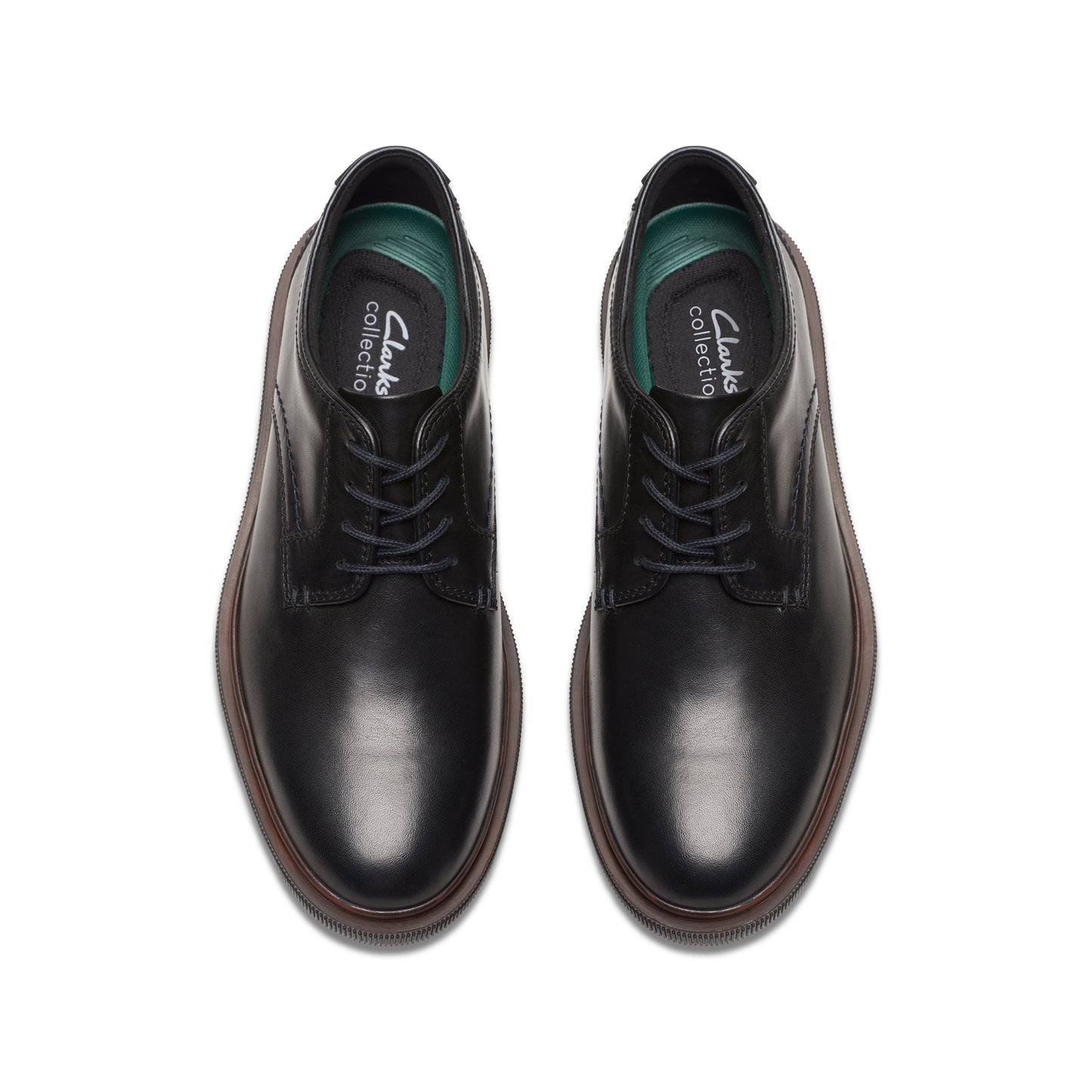 Pair of black leather dress shoes with laces, visible green insole.