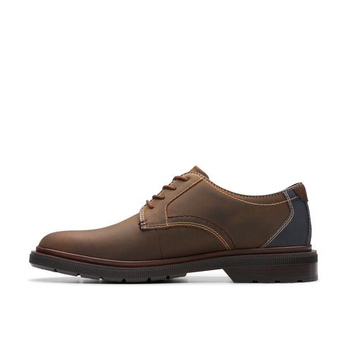 Brown leather dress shoe with contrast stitching.