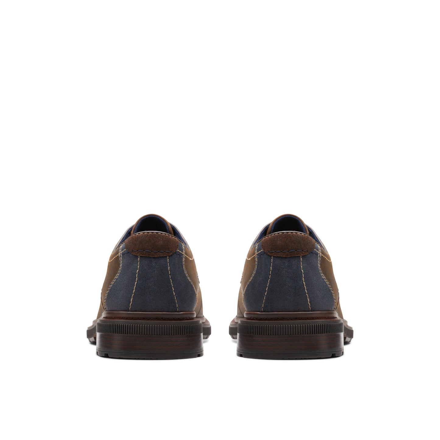 Back view of two brown and navy blue oxford shoes.