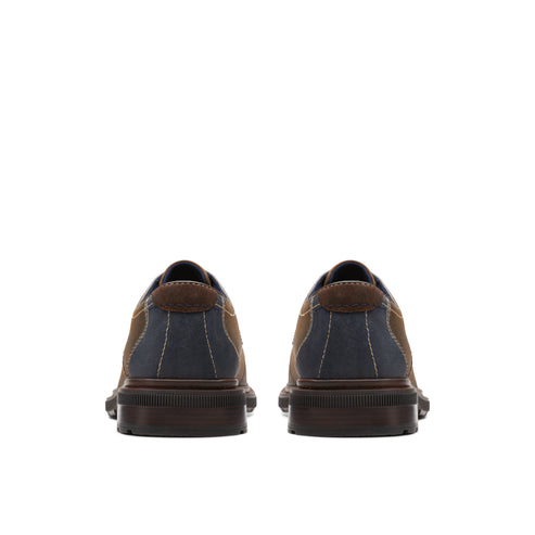 Back view of two brown and navy blue oxford shoes.